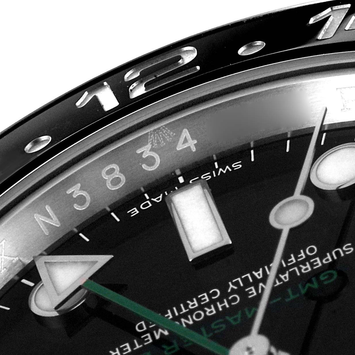 The image shows a close-up angle of the Rolex GMT-Master 116710 Men
s Stainless Steel Black Dial 116710 Men
s Stainless Steel Black Dial watch, focusing on the bezel, part of the dial, and the hour markers.