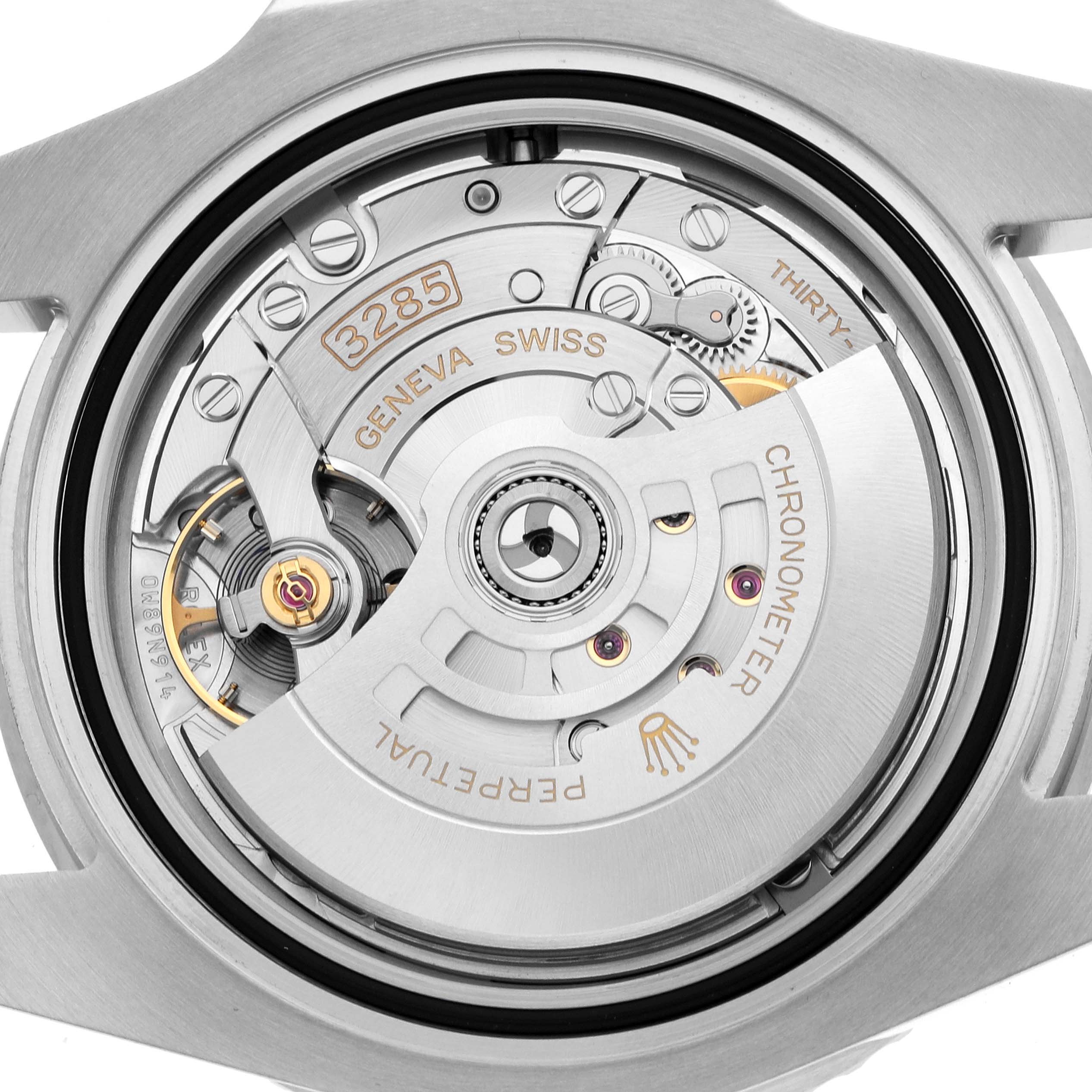 This image shows the movement of a Rolex GMT-Master 126710GRNR Men's Stainless Steel Black Dial, focusing on the intricate components of its mechanical inner workings.