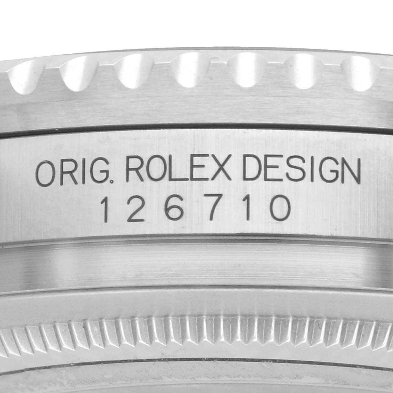 The image shows the side of a Rolex GMT-Master 126710GRNR Men's Stainless Steel Black Dial model 126710 with its reference number and grooved bezel.