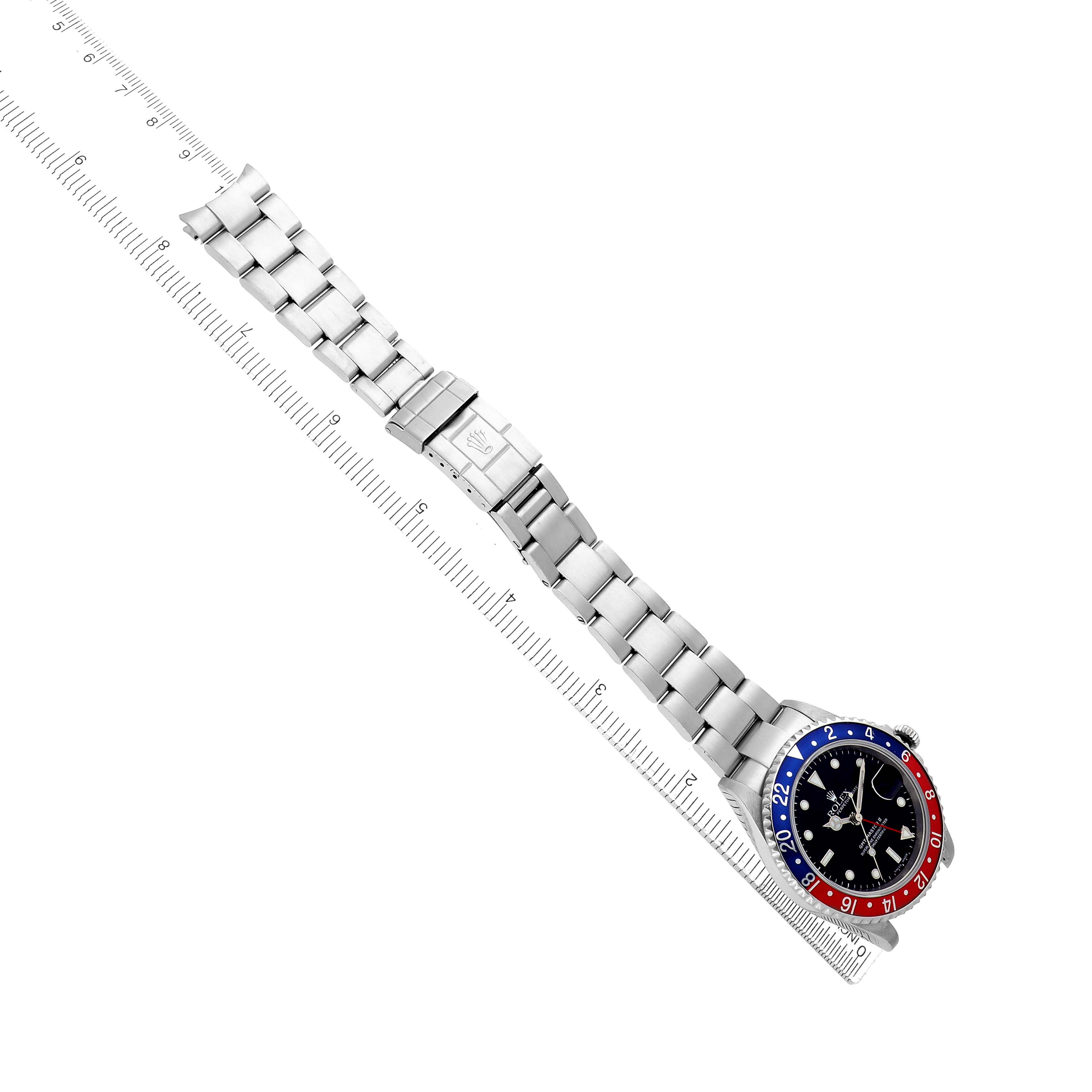 The Rolex GMT-Master 16710 Men's Stainless Steel Black Dial watch is shown from a top-down angle, displaying the full bracelet and the bezel with its red and blue accents.