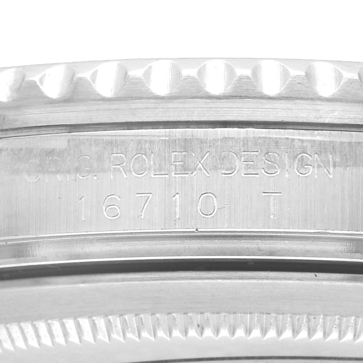 The image shows the side of a Rolex GMT-Master 16710 Men's Stainless Steel Black Dial watch, focusing on the engraved model number and design inscription.