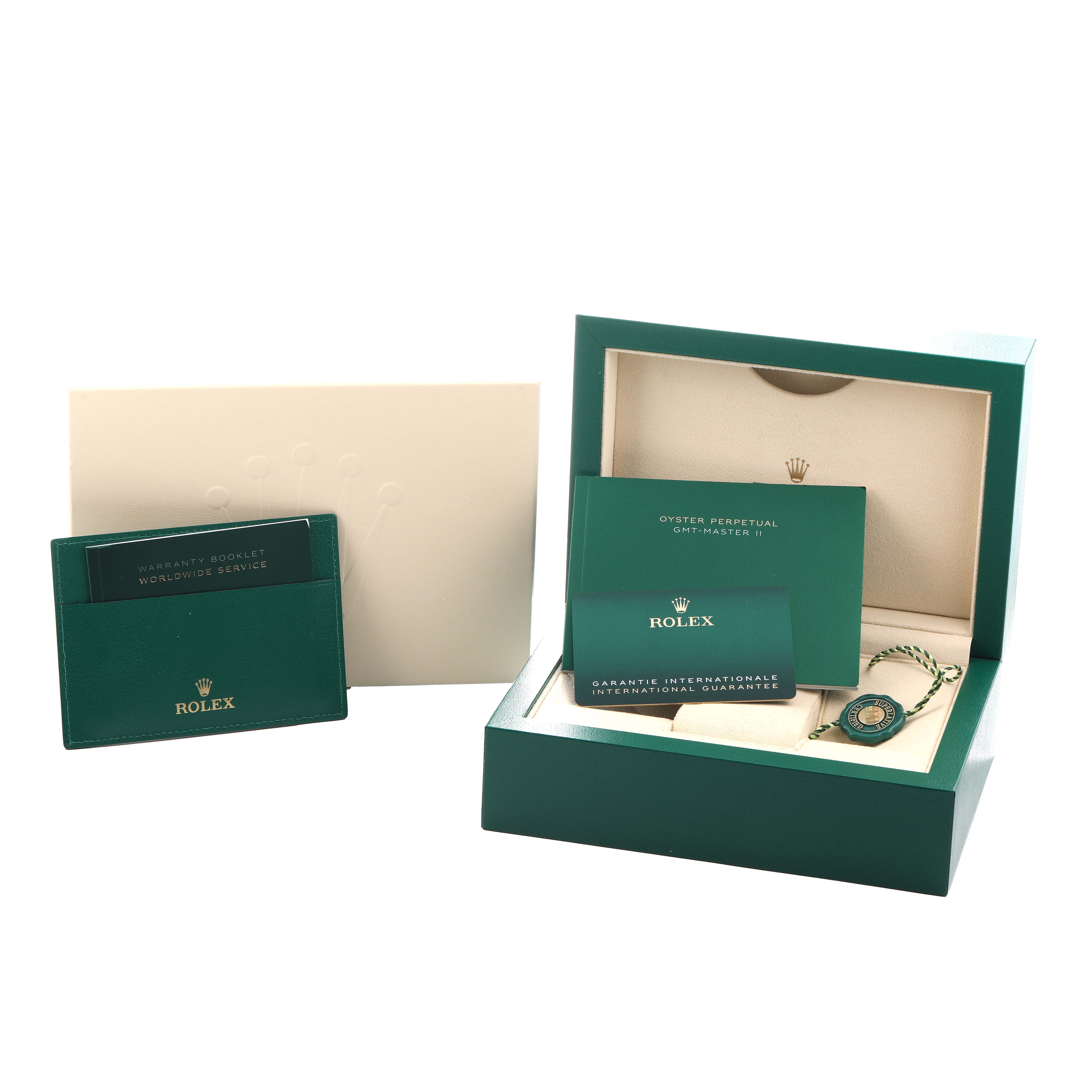 The image shows a Rolex GMT-Master 126710 Men's Stainless Steel Black Dial watch box, warranty booklet, and guarantee card from a side angle.