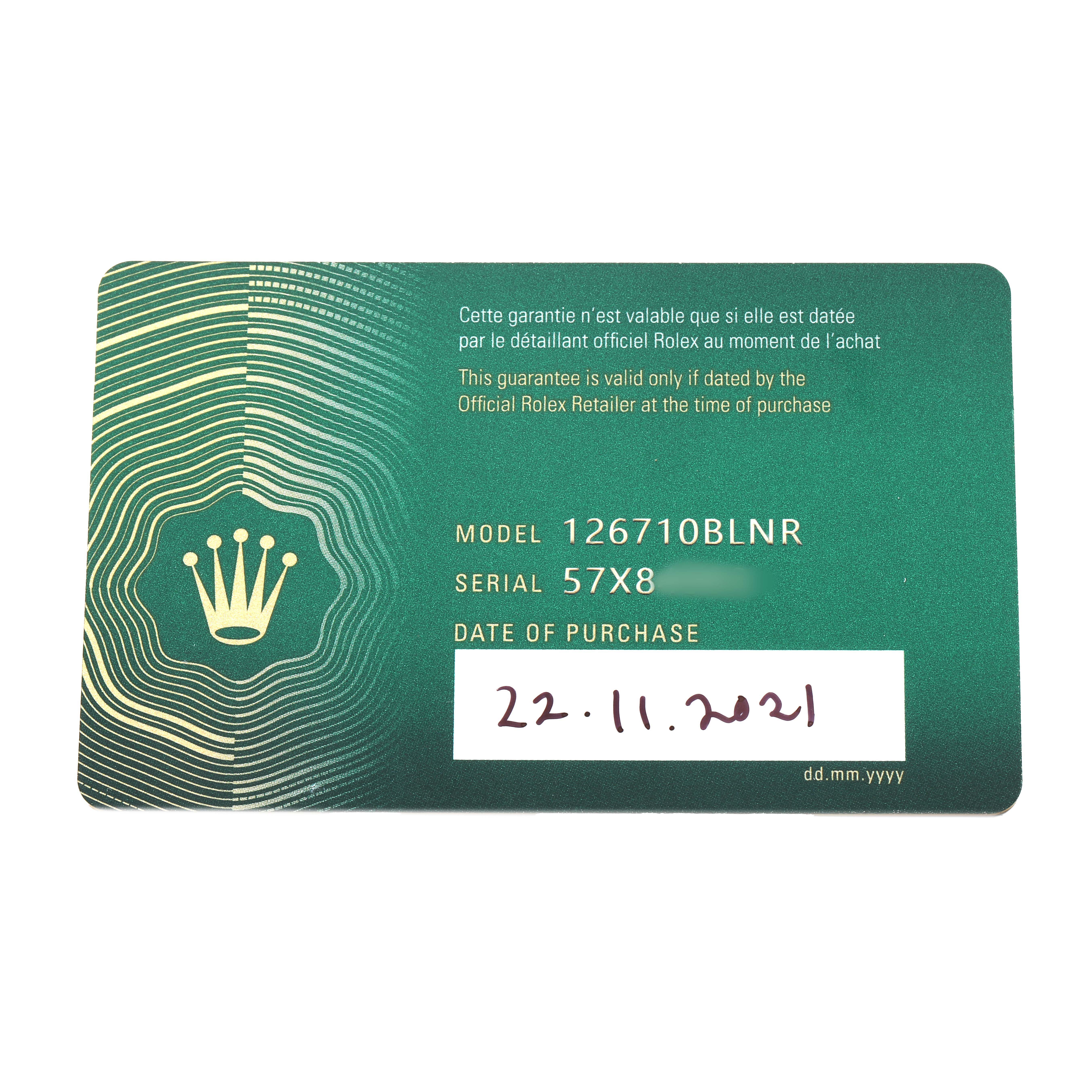 The image shows a green Rolex warranty card for the GMT-Master model, displaying the model number and purchase date.