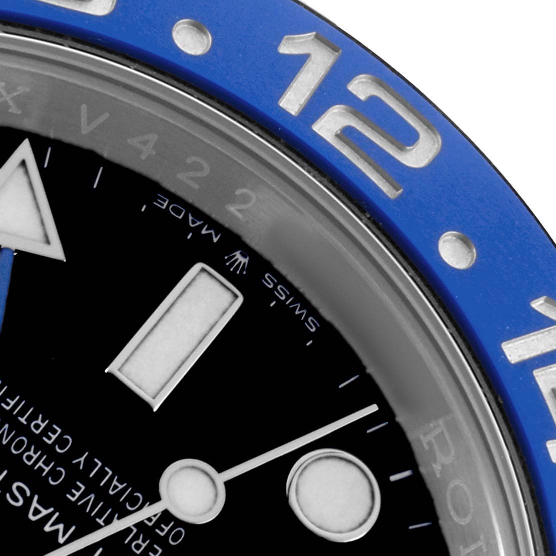The image shows a close-up of the Rolex GMT-Master 126710BLNR Men's Stainless Steel Black Dial's blue bezel, part of the dial, and hands.