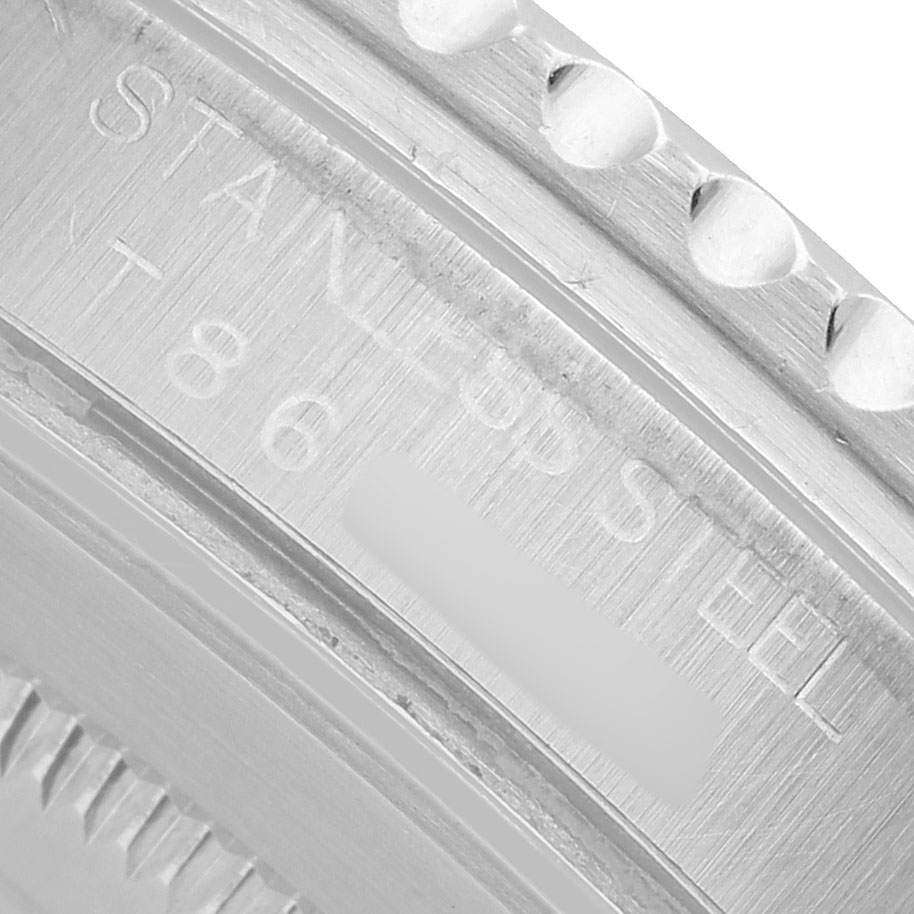 The image shows a close-up of the inner bezel engraving on a Rolex GMT-Master 16700 Men's Stainless Steel Black Dial, highlighting "STAINLESS STEEL."