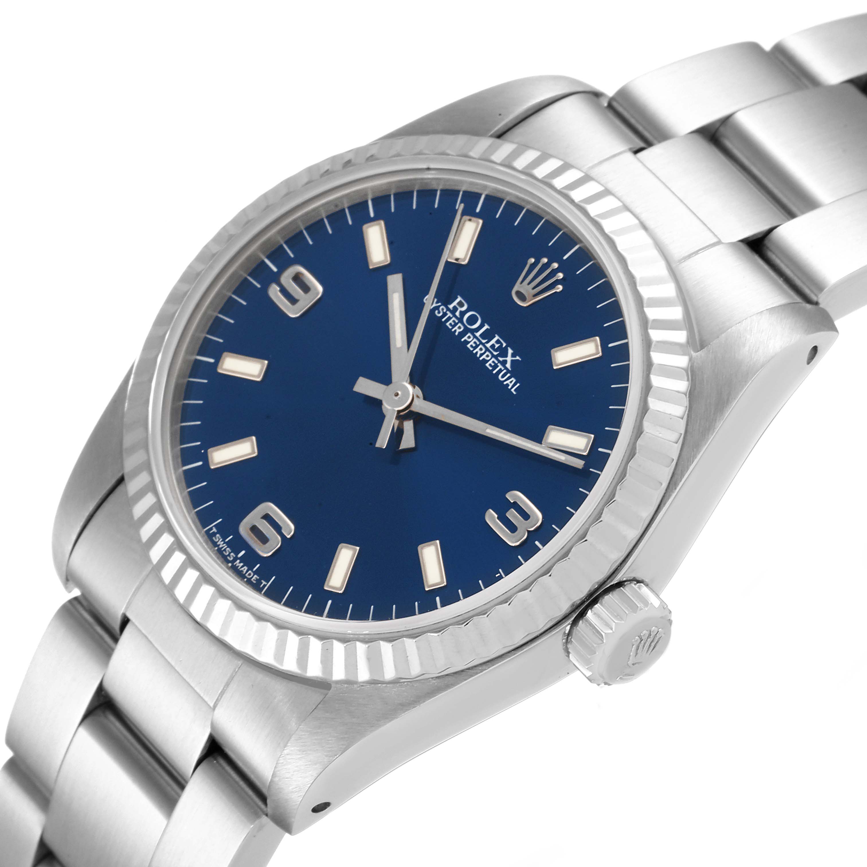 The image shows a side angle of a Rolex Mid-Size 67514 Women
s Stainless Steel Blue Dial 67514 Women
s Stainless Steel Blue Dial watch, highlighting the dial, bezel, crown, and part of the bracelet.