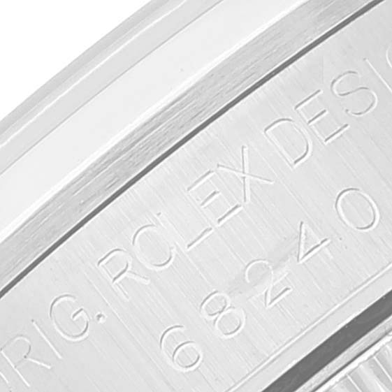 This close-up image shows the engraved serial number and "ROLEX DESIGN" on the case of a Rolex Datejust 68240 Women's Stainless Steel Pink Dial 68240 Women's Stainless Steel Pink Dial watch.