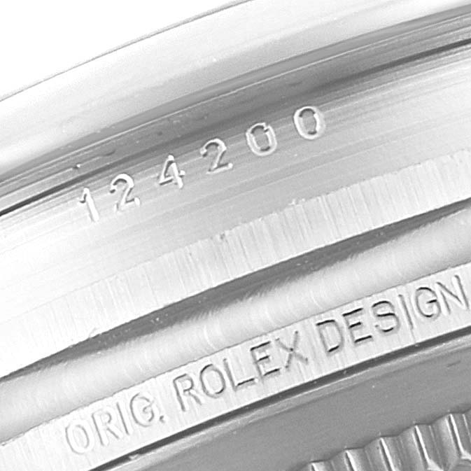 This image shows a close-up of the casing side of a Rolex Oyster Perpetual 124200 Men
s Stainless Steel Black Dial 124200 Men
s Stainless Steel Black Dial watch, highlighting the engraved model number and design details.