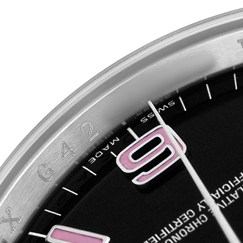 The image shows a close-up of the Rolex Oyster Perpetual 116000 Men's Stainless Steel Black Dial's dial and the edge of the bezel, highlighting numerals and markings.