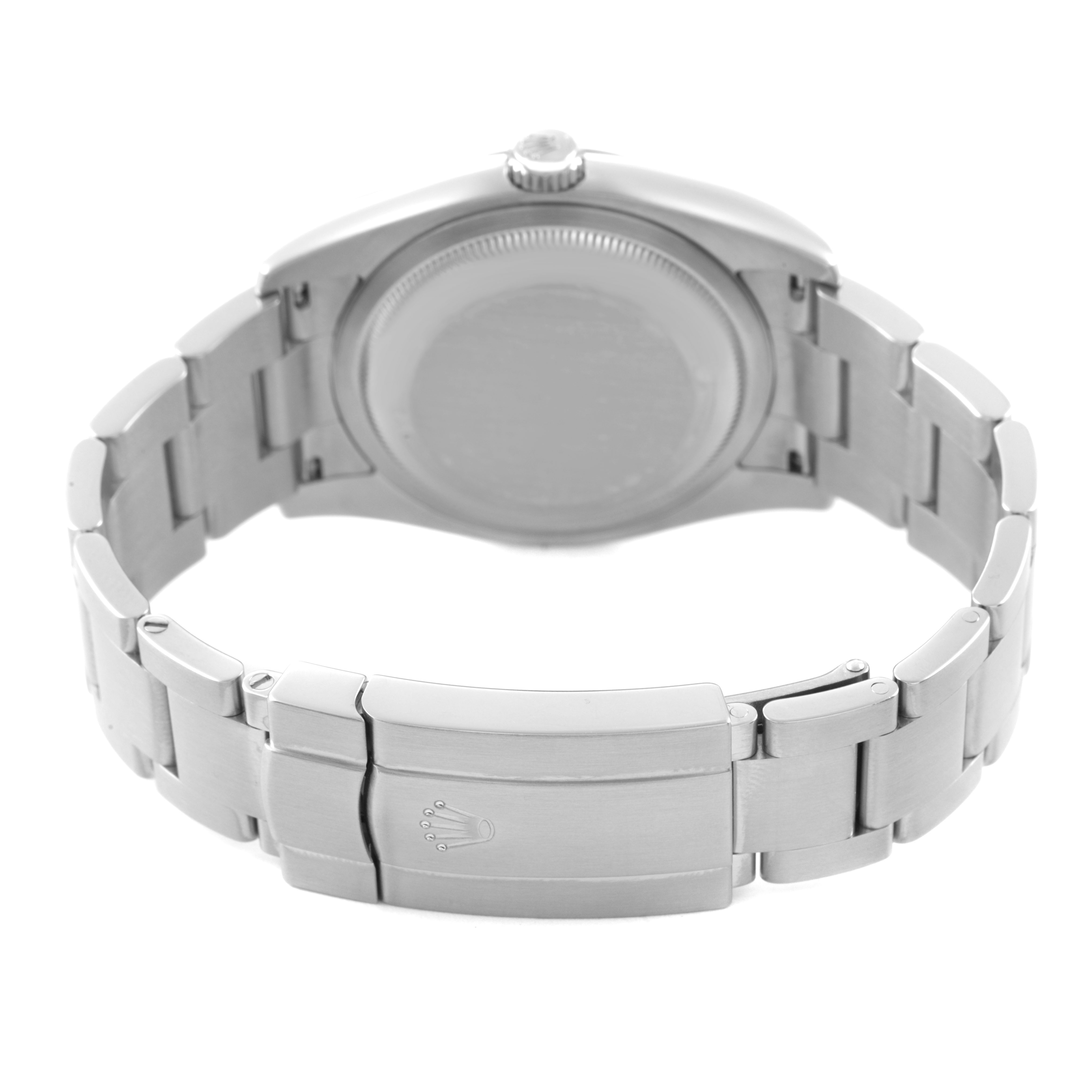 The image shows the back of a Rolex Oyster Perpetual 116000 Men's Stainless Steel Silver Dial watch, focusing on the closed clasp and bracelet.