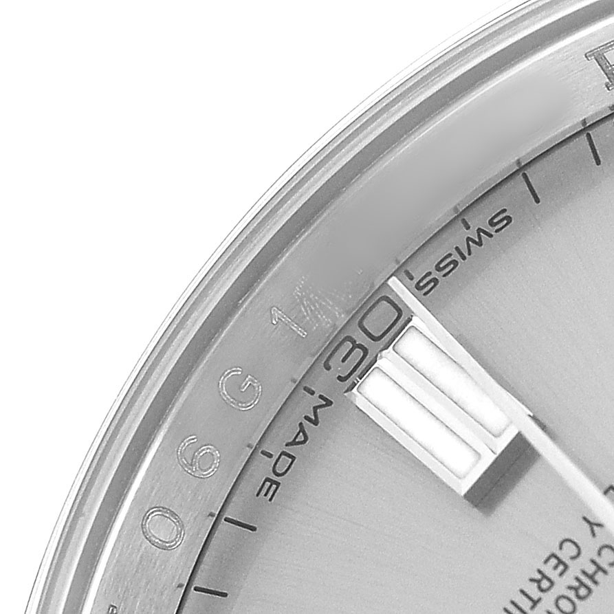 The image shows a close-up of the dial's edge of the Rolex Oyster Perpetual 116000 Men's Stainless Steel Silver Dial, including a portion of the 30-minute marker and Swiss made label.