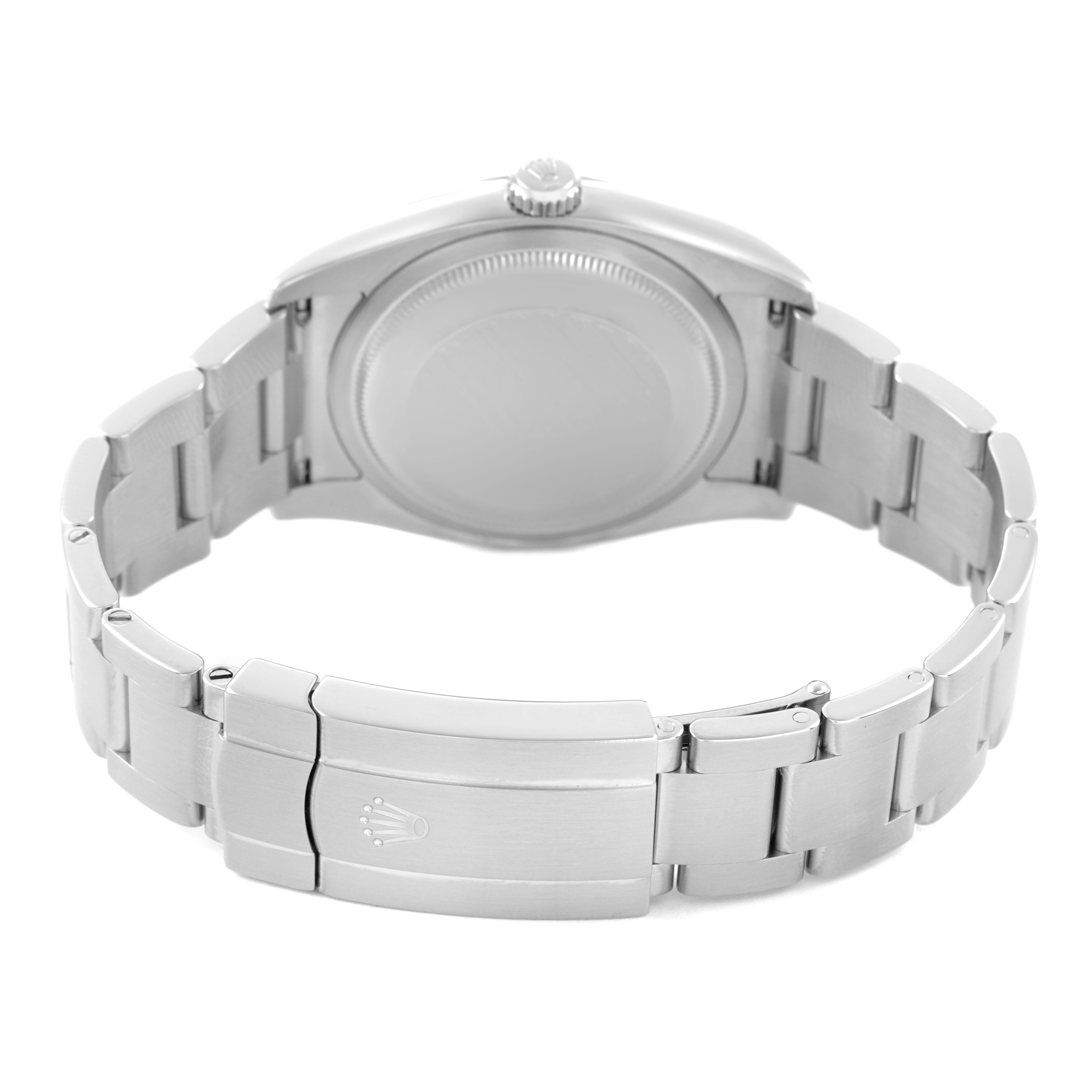 The image shows the backside of the Rolex Oyster Perpetual 116000 Men's Stainless Steel Silver Dial watch, highlighting the clasp and bracelet links.