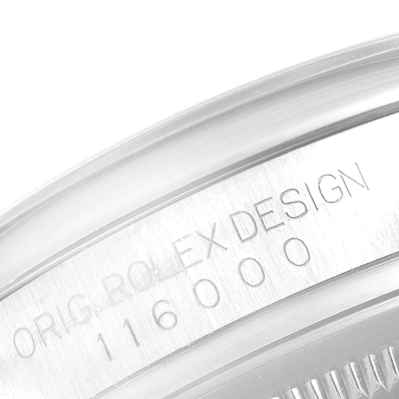 The image shows a close-up of the engraved bezel of the Rolex Oyster Perpetual 116000 Men's Stainless Steel Silver Dial, highlighting "ORIG ROLEX DESIGN" and the model number.
