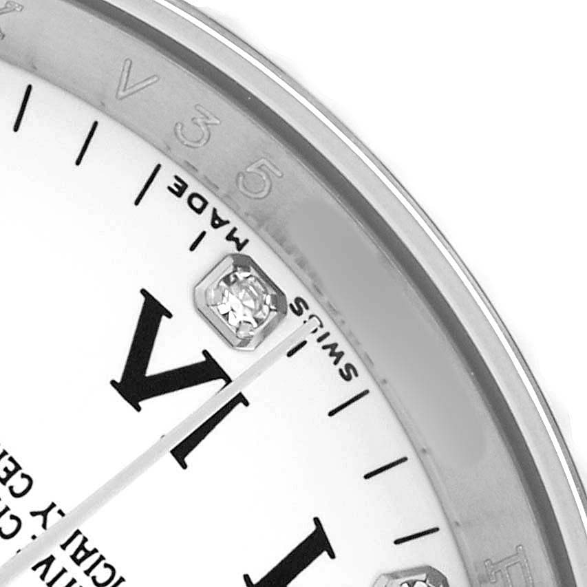 The image shows a close-up of the Rolex Oyster Perpetual 116034 Men
s Stainless Steel White Dial watch face, highlighting the Roman numeral, diamond marker, and "Swiss Made" text.