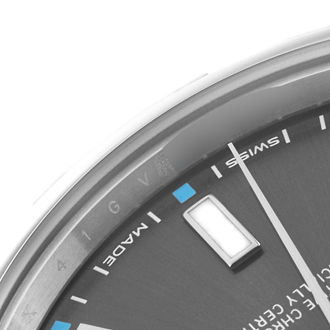 This image of the Rolex Oyster Perpetual 114300 Men's Stainless Steel Grey Dial 114300 Men's Stainless Steel Grey Dial watch shows a close-up of the dial, highlighting the hour markers, minute hand, and "Swiss made" text.