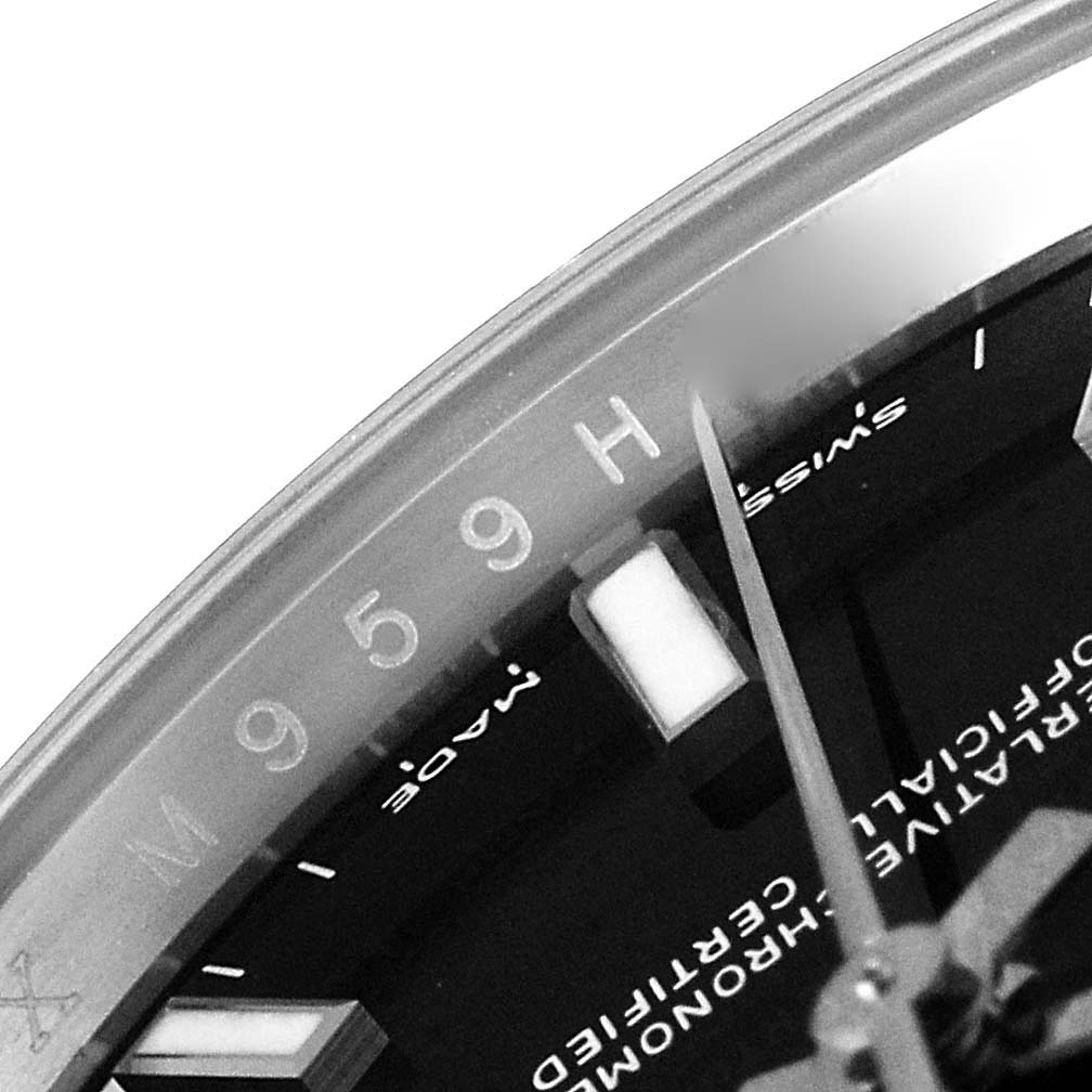 The image of the Rolex Oyster Perpetual 114200 Men
s Stainless Steel Black Dial 114200 Men
s Stainless Steel Black Dial watch shows a close-up of the dial and bezel, highlighting the "Swiss Made" text and hour markers.