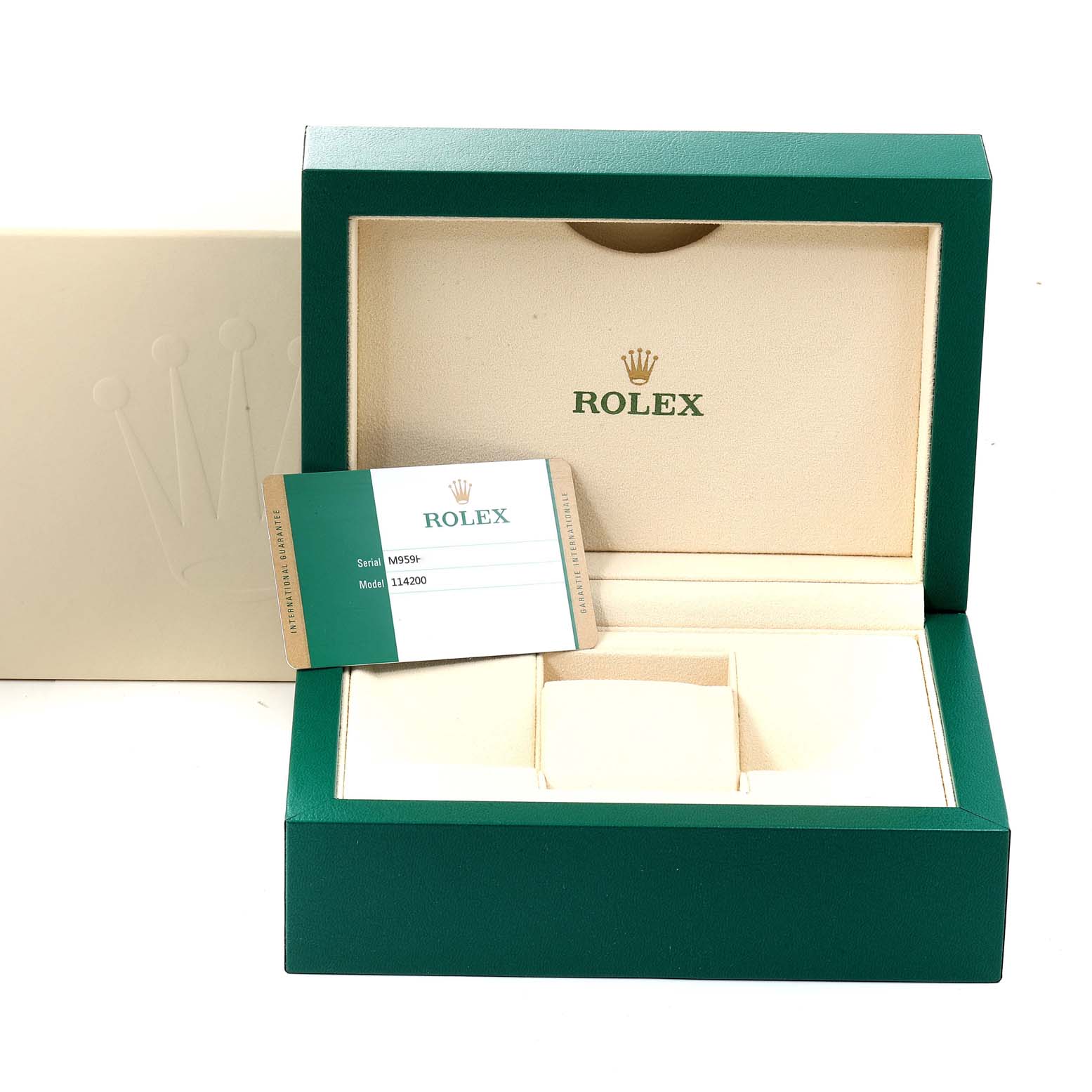 This image shows an open Rolex Oyster Perpetual 114200 Men
s Stainless Steel Black Dial 114200 Men
s Stainless Steel Black Dial watch box at an angle, displaying the interior and warranty card.