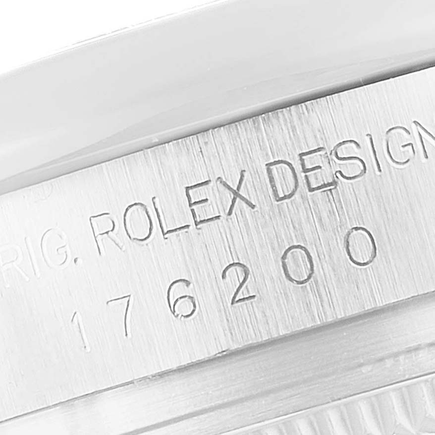 The image shows a close-up of the model number and the Rolex engraving on the side of an Oyster Perpetual watch.
