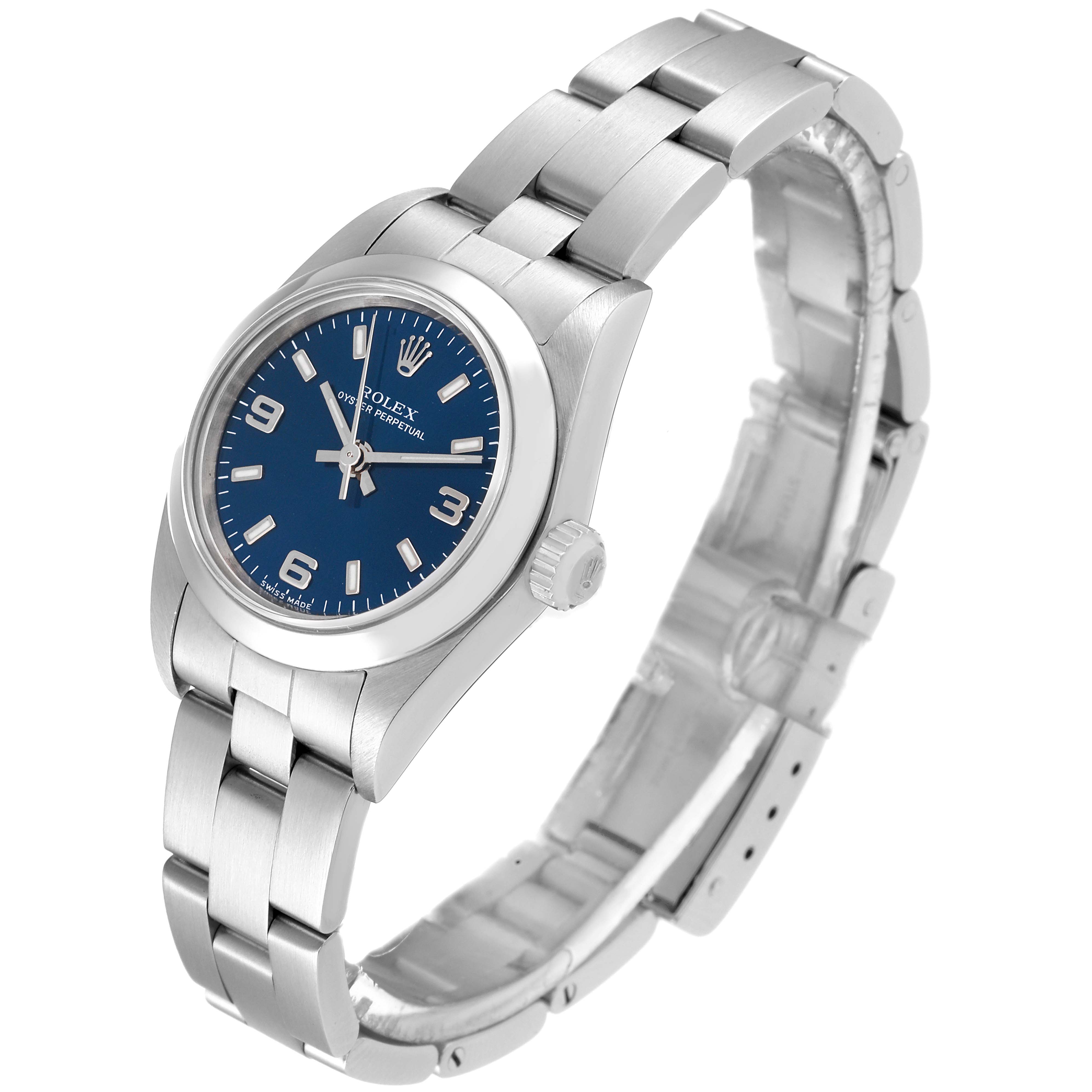The image shows a side view of the Rolex Oyster Perpetual 76080 Women
s Stainless Steel Blue Dial 76080 Women
s Stainless Steel Blue Dial watch, highlighting the blue dial, bracelet, and crown.