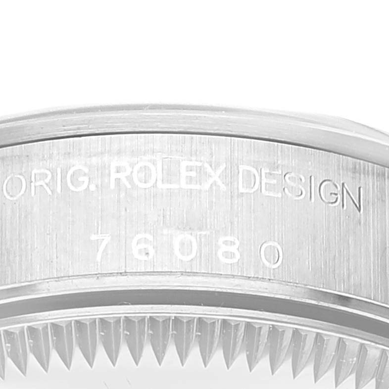 This image shows the side engraving and part of the bezel of the Rolex Oyster Perpetual 76080 Women
s Stainless Steel Blue Dial 76080 Women
s Stainless Steel Blue Dial watch.