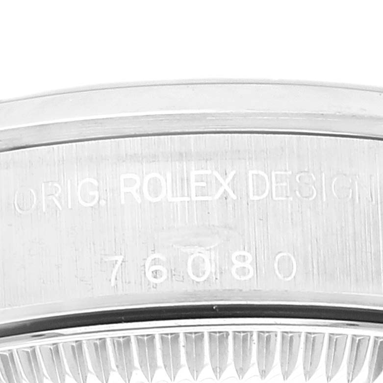 The image shows a close-up of the engraved bezel of a Rolex Oyster Perpetual 76080 Women
s Stainless Steel Blue Dial 76080 Women
s Stainless Steel Blue Dial watch.