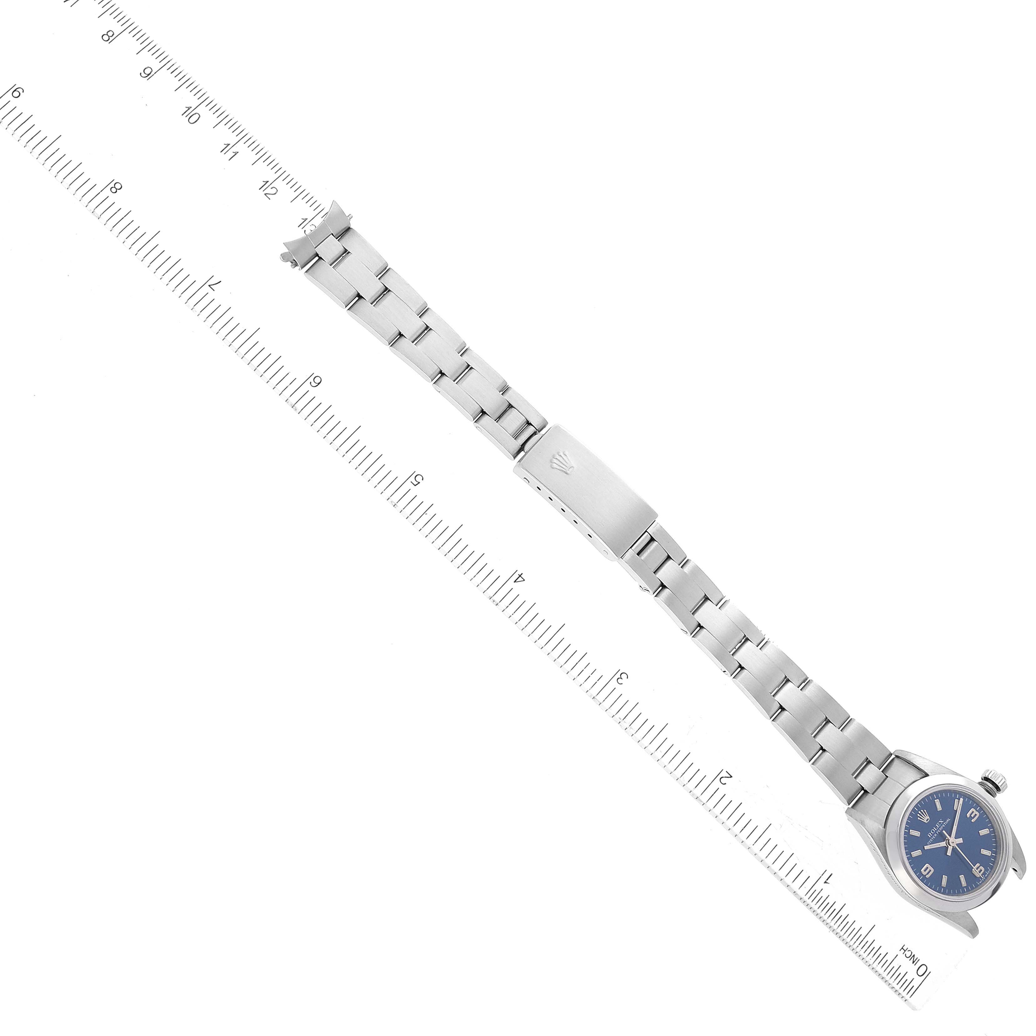 The image shows a Rolex Oyster Perpetual 76080 Women
s Stainless Steel Blue Dial 76080 Women
s Stainless Steel Blue Dial watch laid flat with a full view of the dial, bracelet, and clasp from a top-down angle.