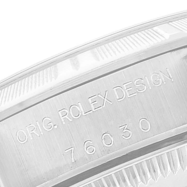 This image shows a close-up of the engraved case back border of a Rolex Oyster Perpetual 76030 Women
s Stainless Steel Pink Dial 76030 Women
s Stainless Steel Pink Dial model.