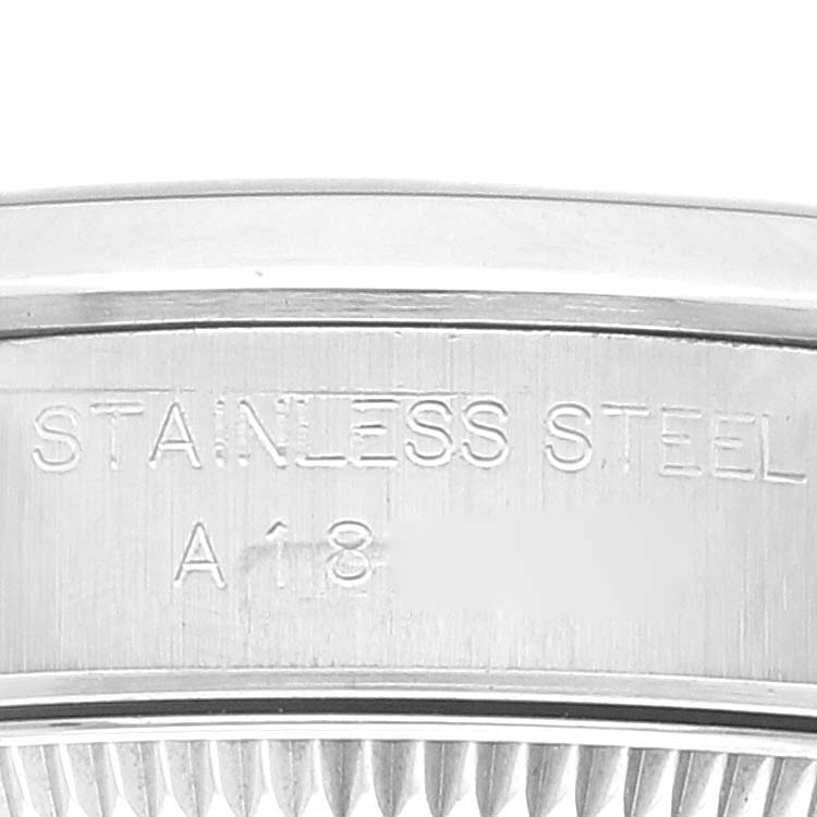 This close-up shows the stainless steel casing and part of the fluted bezel of a Rolex Oyster Perpetual 76080 Women's Stainless Steel Pink Dial 76080 Women's Stainless Steel Pink Dial watch.