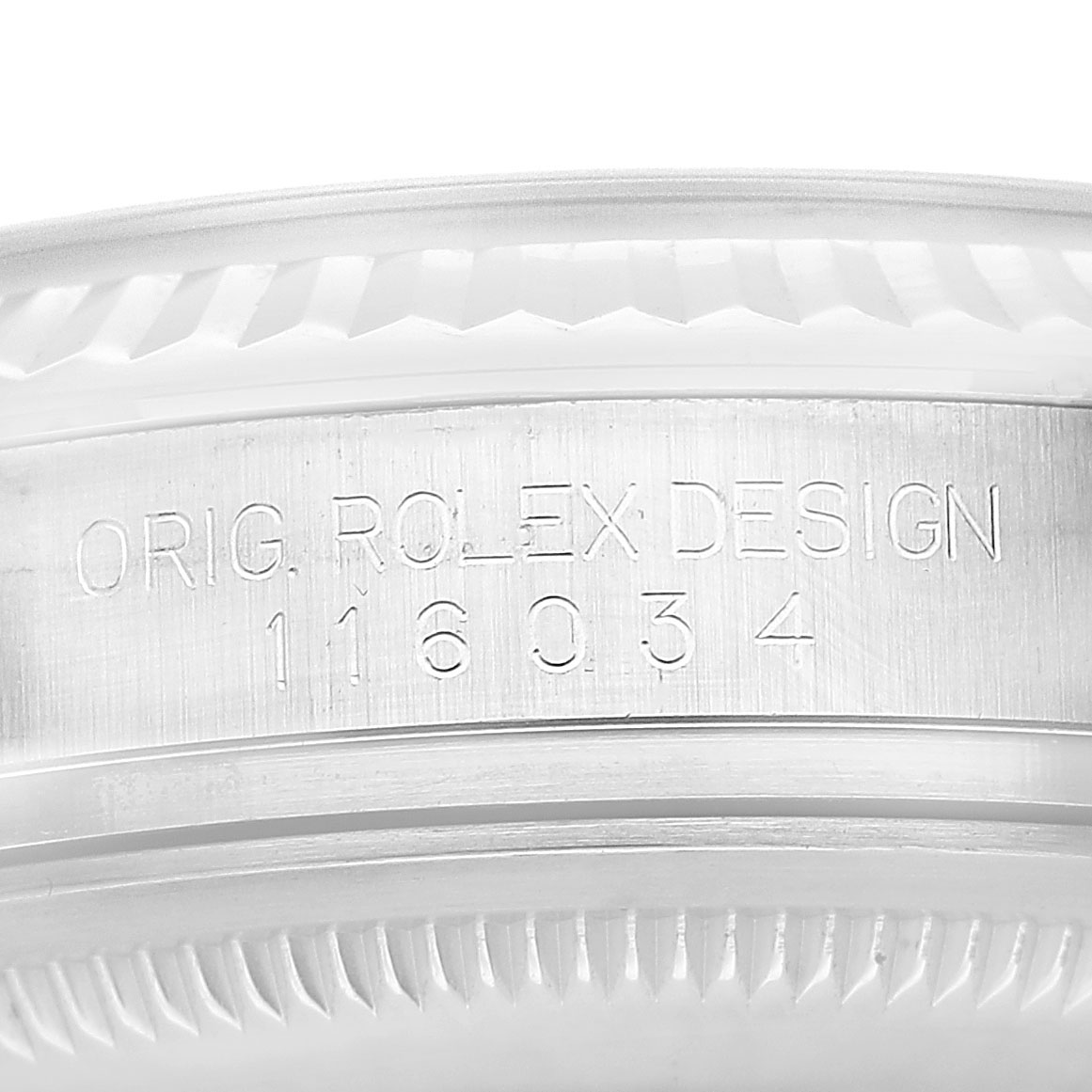 The image shows a close-up of the watch's edge with the engraving "ORIG. ROLEX DESIGN" on the Rolex Oyster Perpetual 116034 Men's Stainless Steel Silver Dial.