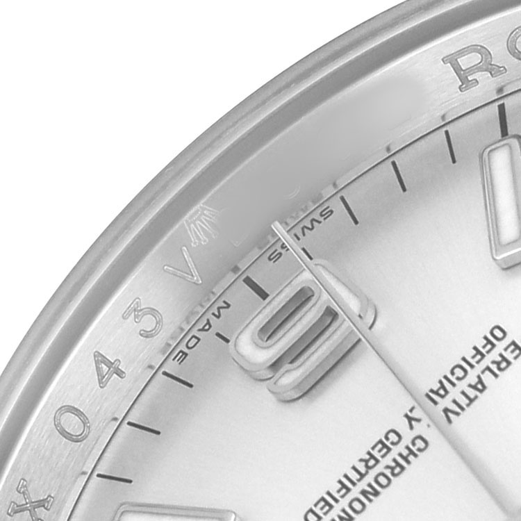 The image shows a close-up of the dial and bezel of a Rolex Oyster Perpetual 116034 Men's Stainless Steel Silver Dial watch, highlighting the numbers and markers.