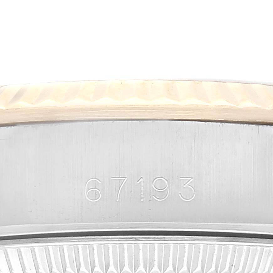 This image shows a close-up of the side and the engraved model number of a Rolex Oyster Perpetual 67193 Women's Steel and Gold (two tone) Champagne Dial 67193 Women's Steel and Gold (two tone) Champagne Dial watch.