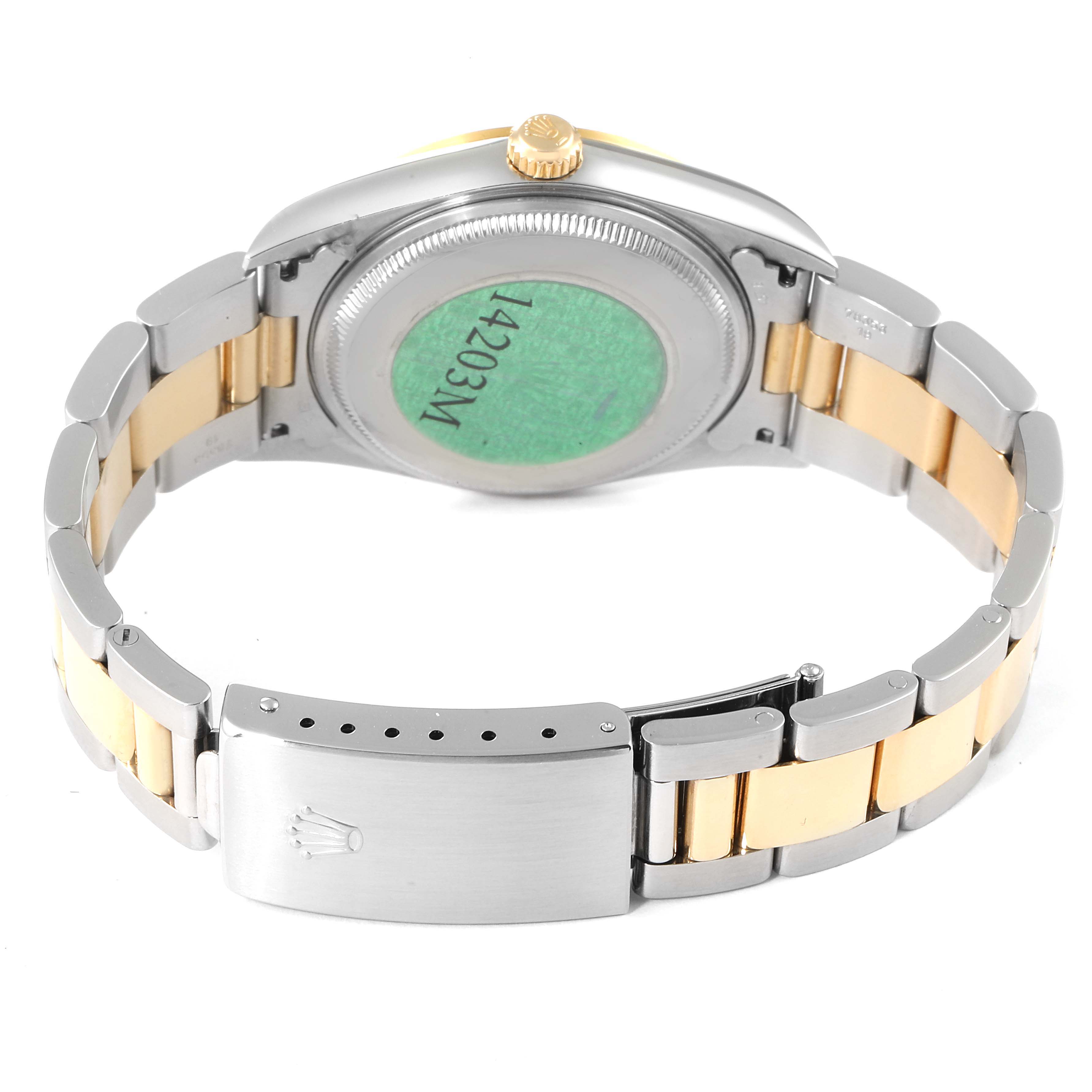 The image shows the back view of a Rolex Oyster Perpetual 14203 Men's Steel and Gold (two tone) Silver Dial 14203 Men's Steel and Gold (two tone) Silver Dial watch, highlighting its case back, crown, and two-tone bracelet with a clasp.