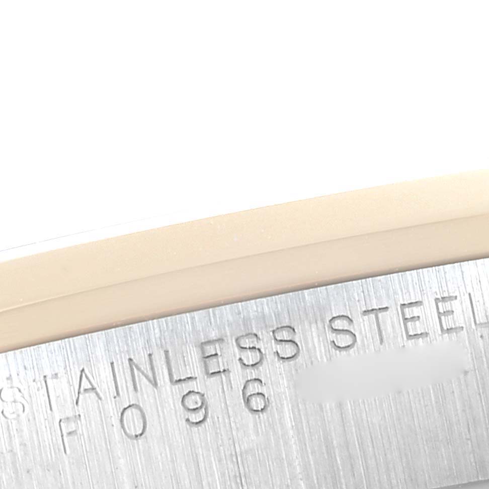 This image shows a close-up view of the stainless steel outer casing of a Rolex Oyster Perpetual 14203 Men's Steel and Gold (two tone) Silver Dial 14203 Men's Steel and Gold (two tone) Silver Dial watch, displaying the engraved text.