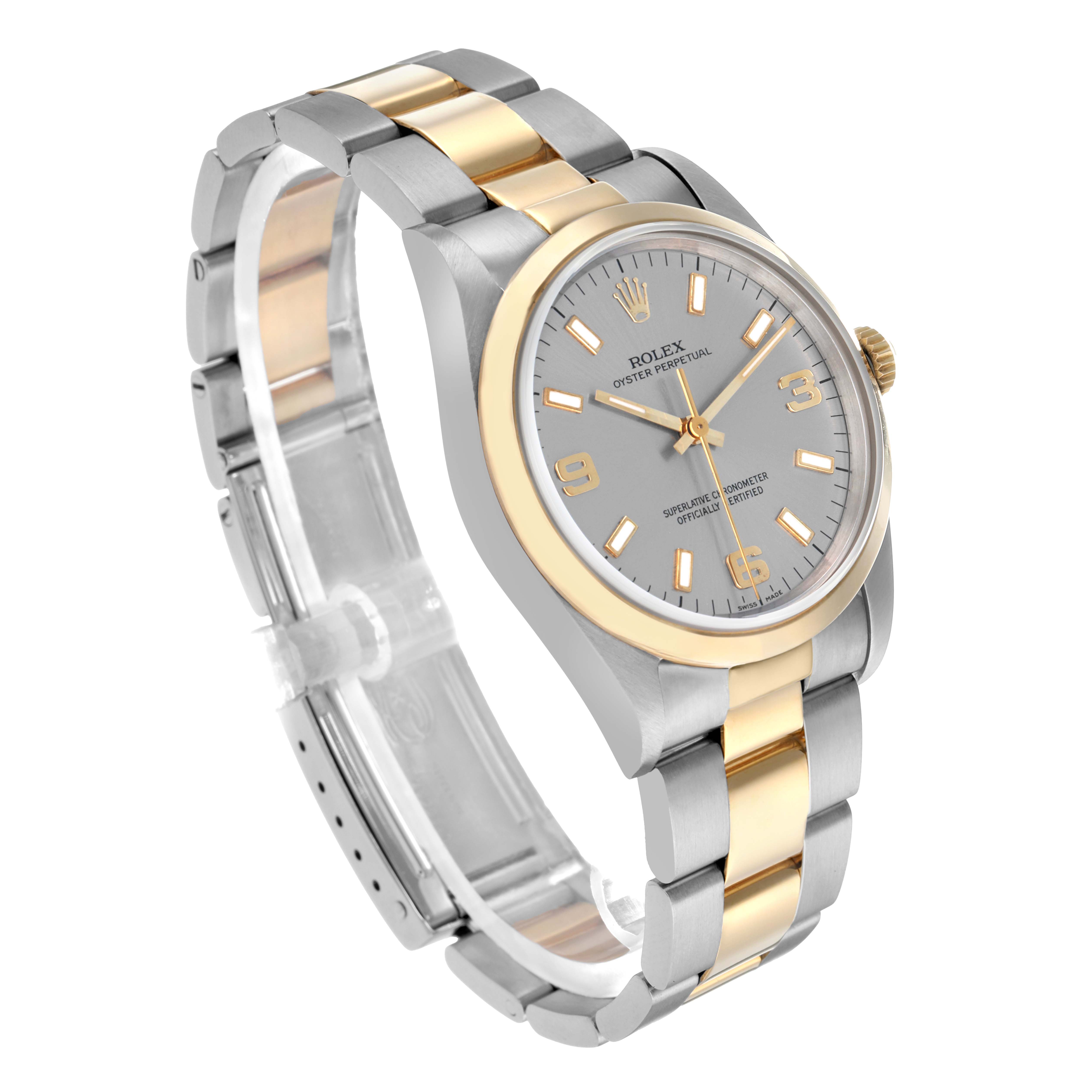 The Rolex Oyster Perpetual 14203 Men
s Steel and Gold (two tone) Silver Dial watch is shown at a three-quarter angle, displaying the face, case, and bracelet.