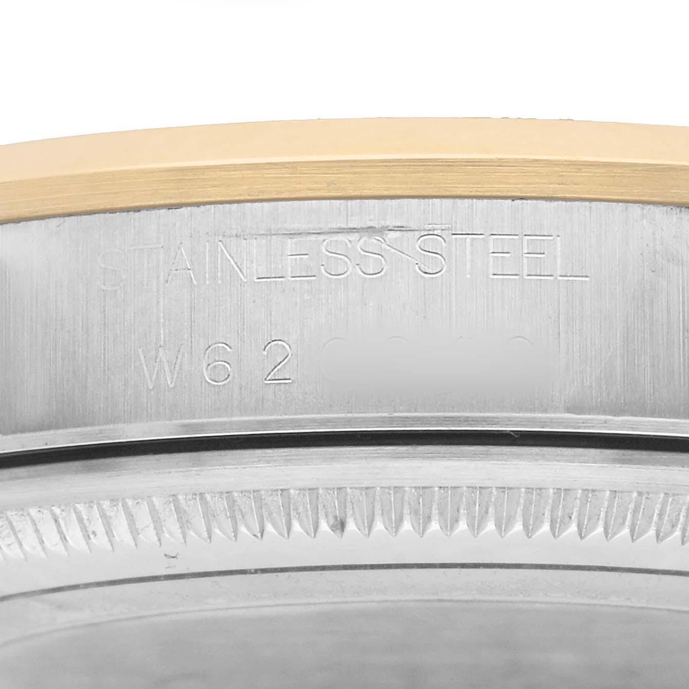 The image shows a close-up of the side of a Rolex Oyster Perpetual 14203 Men
s Steel and Gold (two tone) Silver Dial watch case, highlighting the stainless steel material and bezel.