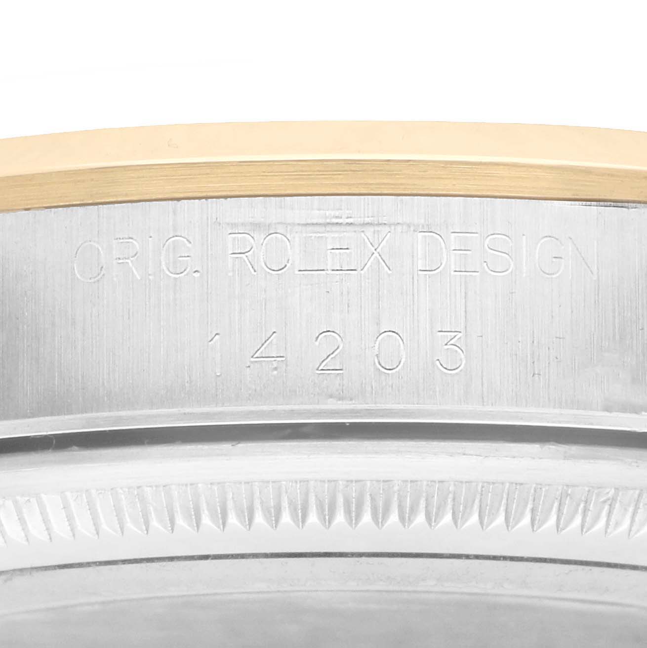 The image shows an angled close-up of the case side of a Rolex Oyster Perpetual 14203 Men
s Steel and Gold (two tone) Silver Dial, highlighting the engraved design number.