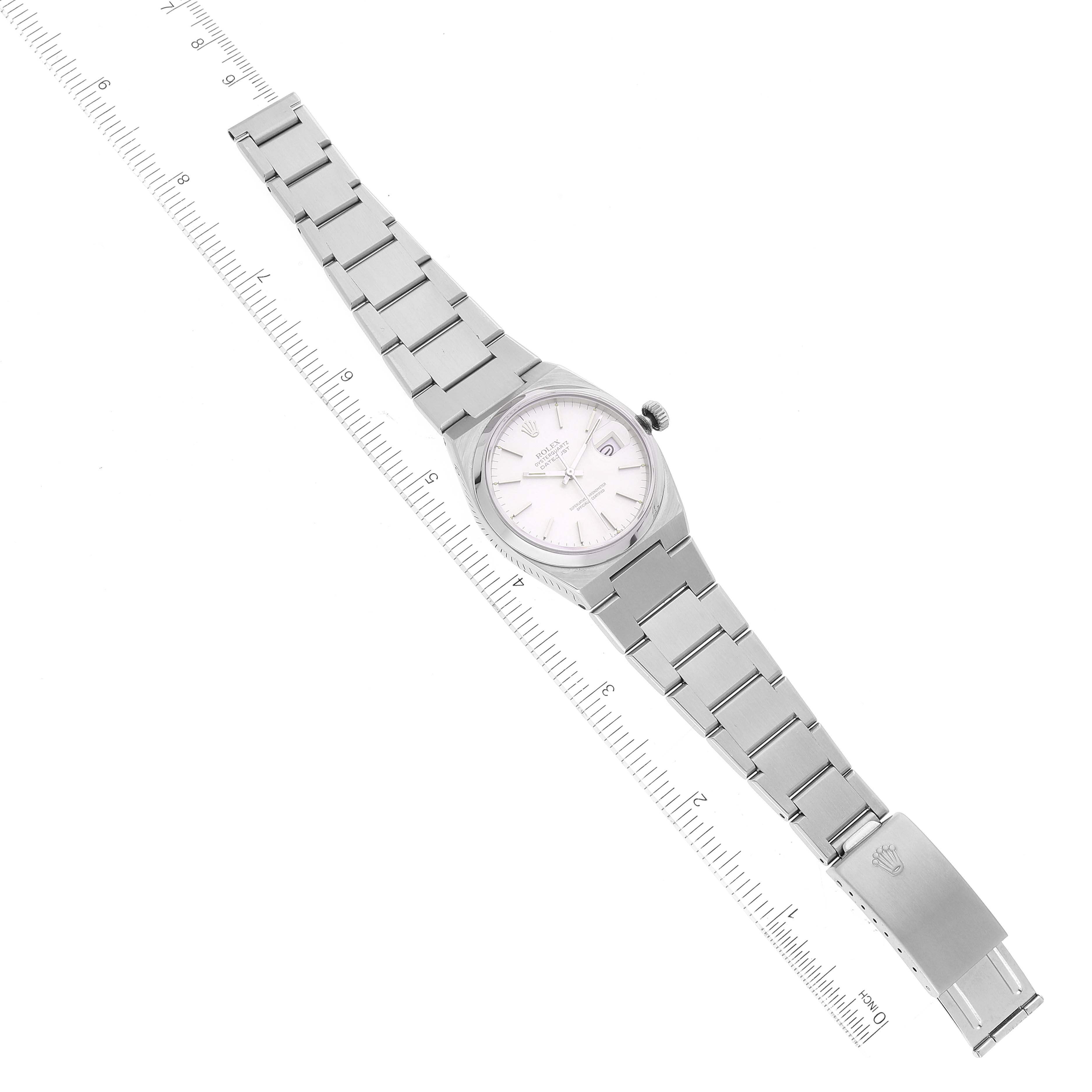 The Rolex Oysterquartz 17000 Men
s Stainless Steel Silver Dial 17000 Men
s Stainless Steel Silver Dial watch is shown from a top-down angle, featuring the full bracelet and dial, alongside a ruler for size reference.