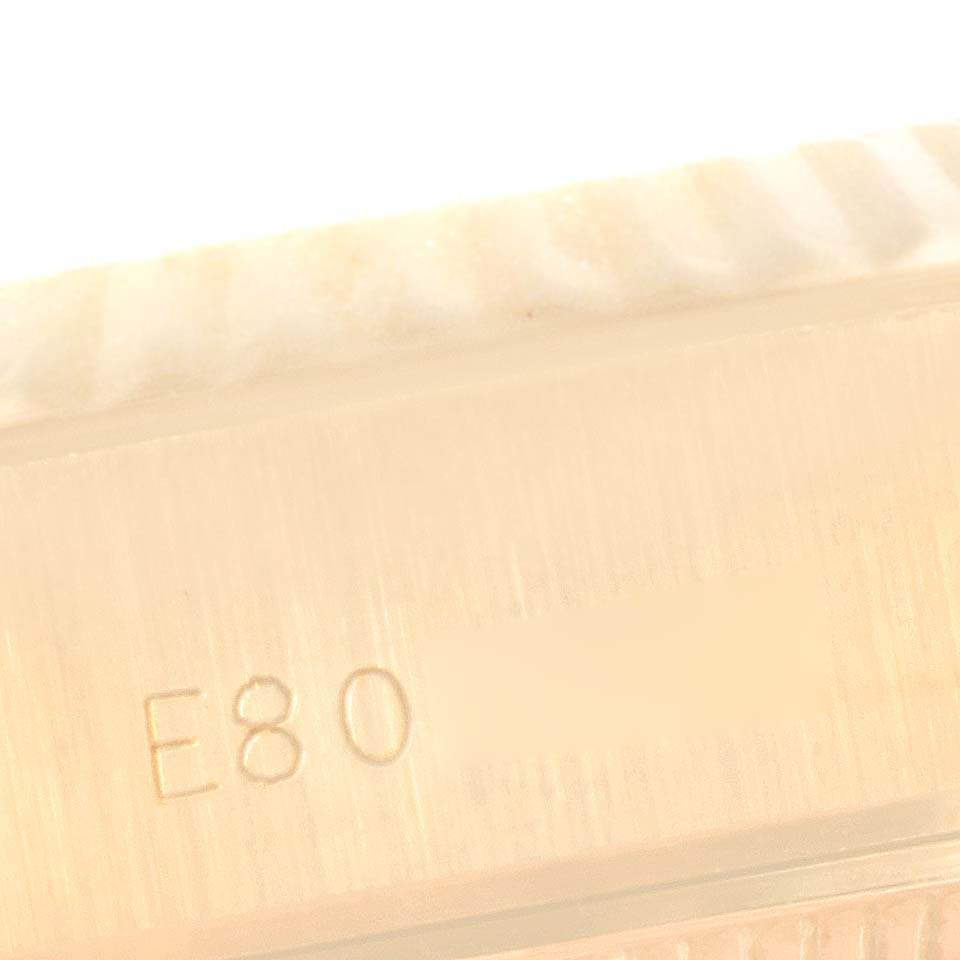 This image shows a close-up view of the side of a Rolex President 69178 Women's Yellow Gold Black Dial 69178 Women's Yellow Gold Black Dial watch, focusing on the case serial number engraving.