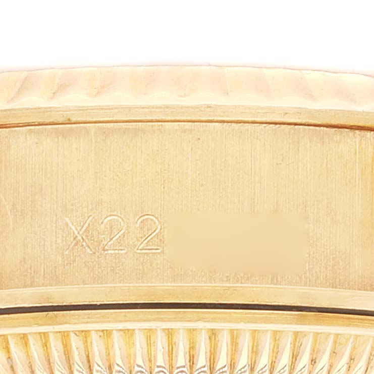 The image shows a close-up of the case side and the fluted bezel of a Rolex President 69178 Women
s Yellow Gold Champagne Dial 69178 Women
s Yellow Gold Champagne Dial model watch, featuring an engraving.
