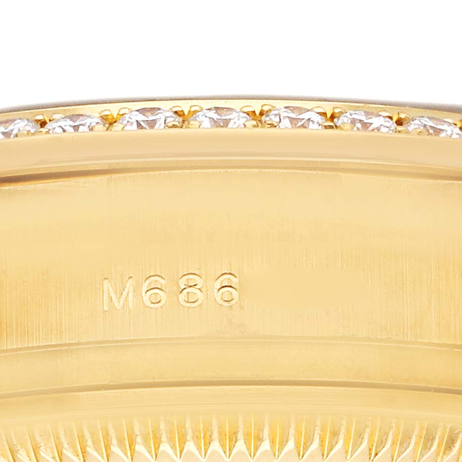 The image shows a close-up of the bezel and part of the case of a Rolex President 179138 Men's Yellow Gold Mother of Pearl Dial model, featuring diamonds and a serial number.