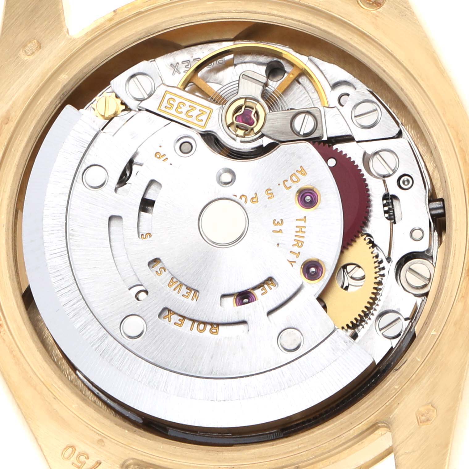 The image shows the movement of a Rolex President 179178 Women's Yellow Gold White Dial watch from a top-down angle, revealing gears and mechanical components.