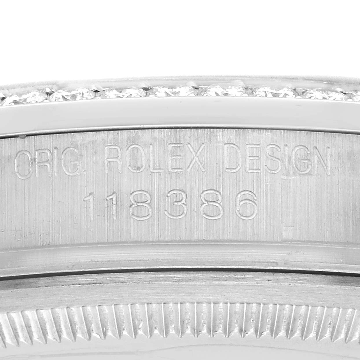 The image shows the side engraving of a Rolex President 118386 Men's Platinum Silver Dial model, highlighting the design number.