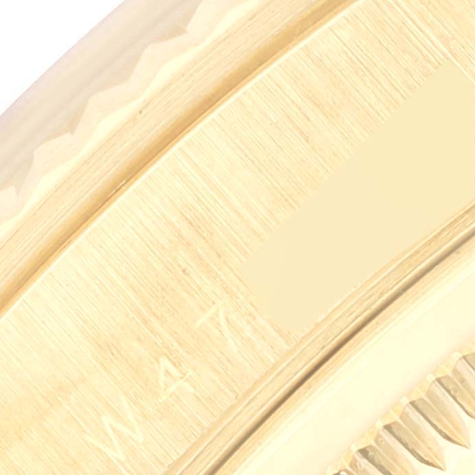 This close-up image shows the side of the case and bezel of a Rolex President 18238 Men's Yellow Gold Beige Dial 18238 Men's Yellow Gold Beige Dial model watch.