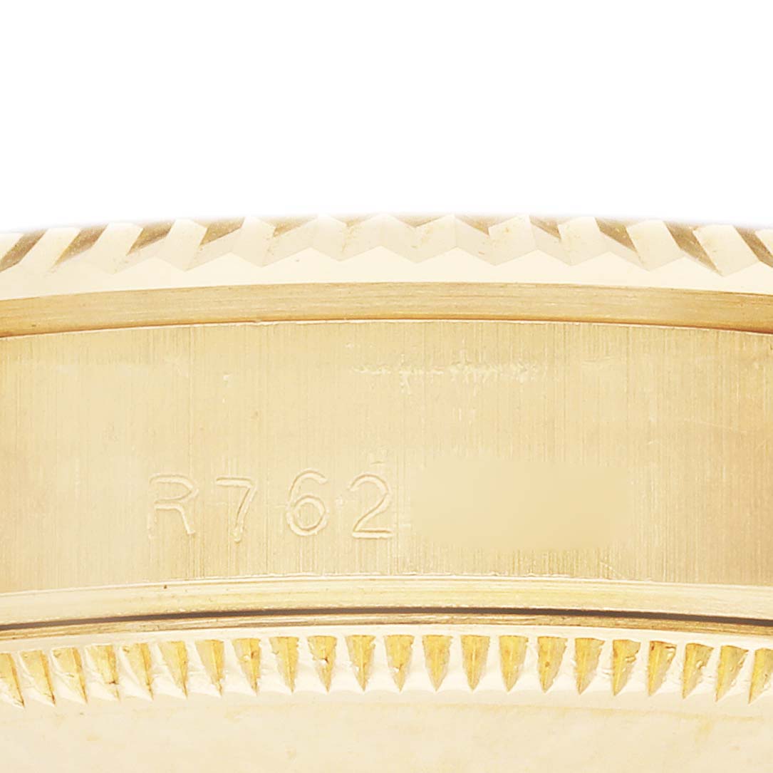 The image shows the side of a Rolex President 68278 Women's Yellow Gold Champagne Dial model watch, focusing on the engraved reference or serial number on the gold case.