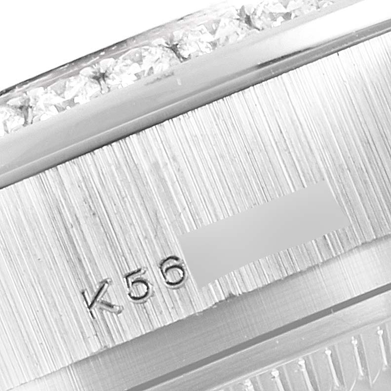 This close-up image shows the engraved markings and diamond-encrusted bezel of a Rolex President 179136 Women's Platinum Mother of Pearl Dial 179136 Women's Platinum Mother of Pearl Dial model watch.