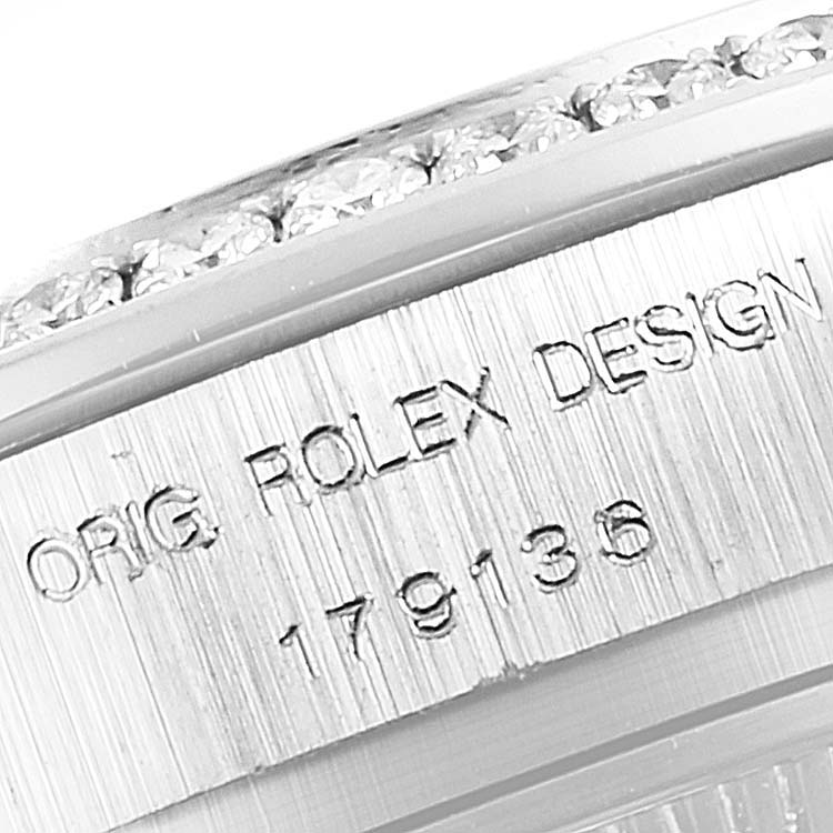 The photo shows a close-up of the side view of the Rolex President 179136 Women's Platinum Mother of Pearl Dial 179136 Women's Platinum Mother of Pearl Dial model, highlighting the engraved "ORIG. ROLEX DESIGN" and model number 179136.