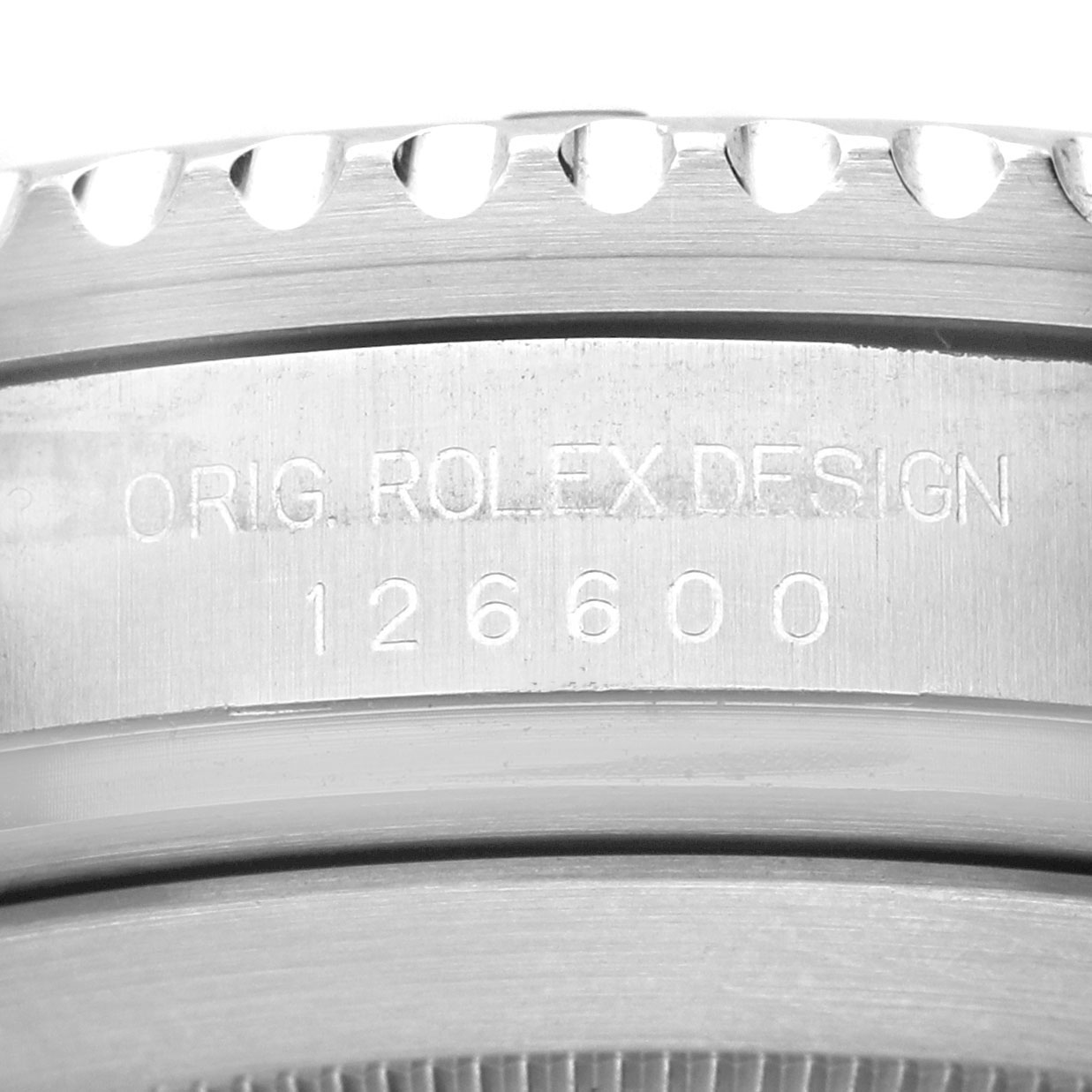 The image shows a close-up of the case side of a Rolex Sea-Dweller 126600 Men's Stainless Steel Black Dial, featuring the engraved "ORIG. ROLEX DESIGN 126600".
