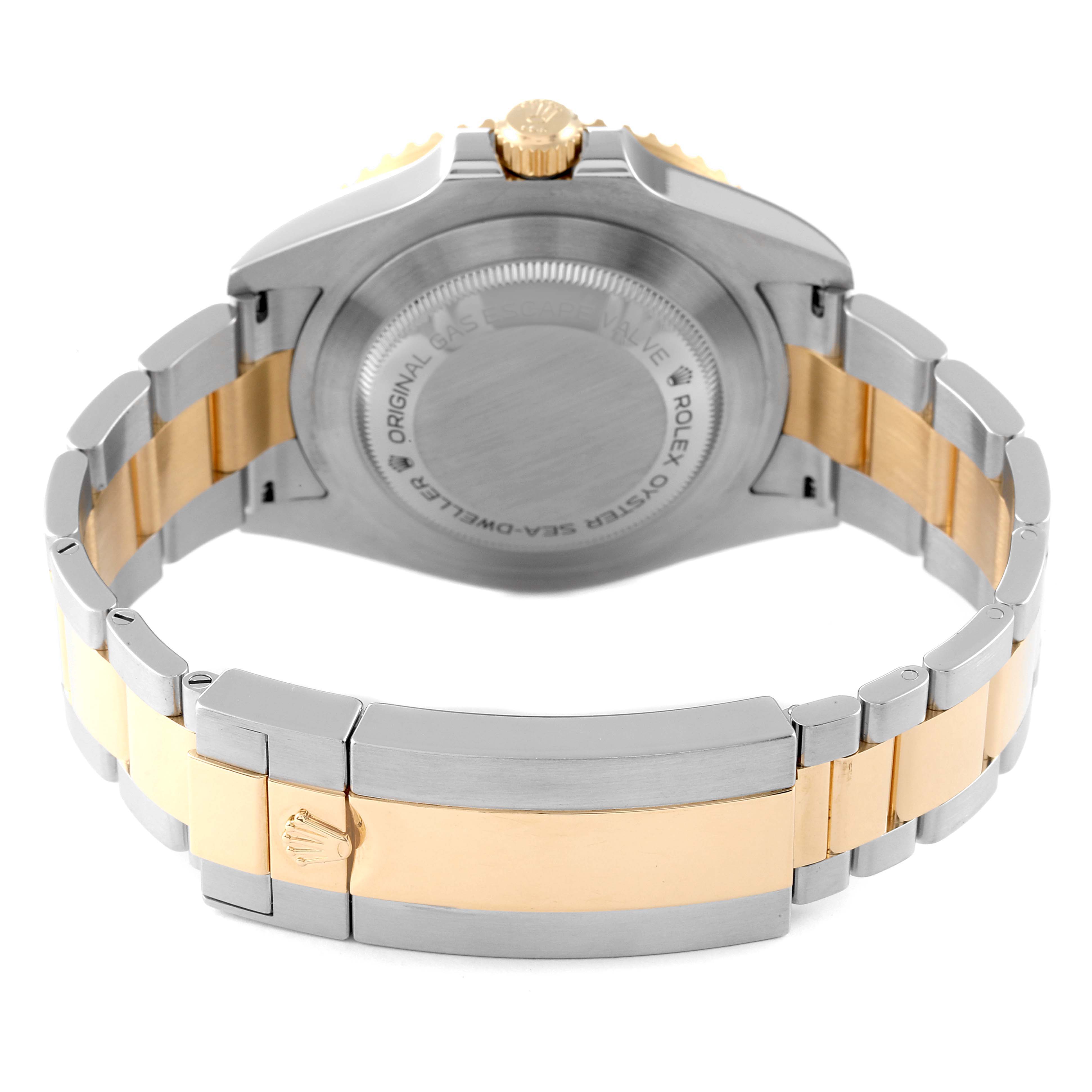 The image shows the back view of the Rolex Sea-Dweller 126603 Men
s Steel and Gold (two tone) Black Dial 126603 Men
s Steel and Gold (two tone) Black Dial watch, highlighting its two-tone bracelet and case back.
