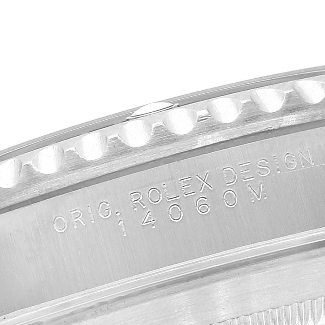 The image shows a close-up view of the bezel and engraved case back of the Rolex Submariner 14060 Men
s Stainless Steel Black Dial 14060 Men
s Stainless Steel Black Dial watch.