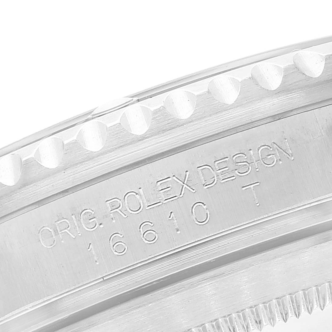 The image shows a close-up of the Rolex Submariner 16610 Men
s Stainless Steel Black Dial 16610 Men
s Stainless Steel Black Dial model, focusing on the engraved case side and part of the bezel.